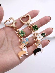 Detail of cute Corgi keychain with heart-shaped lobster clasp and clover charms