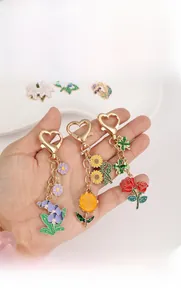 Macro shot of assorted floral metal keychains with heart hooks and colorful enamel finish