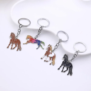 Creative horse keychain set with four colorful metal horse pendants for bag decoration