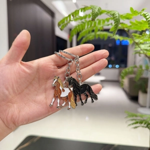 Chic set of two enamel horse keychains in brown and black on a polished metal ring