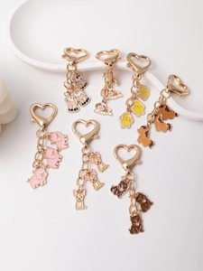 Detail of cartoon animal keychains with gold heart-shaped lobster clasps and alloy charms