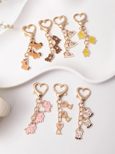 Detailed view of assorted cartoon animal keychains with gold heart-shaped lobster clasps