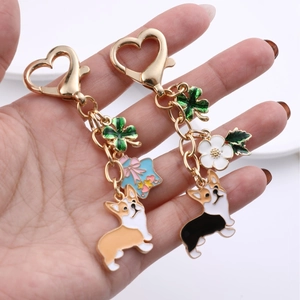 Golden Corgi keychain with heart clasp, green clover and enamel flower pendants