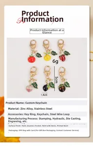 Detailed view of colorful fruit keychains with heart-shaped golden clips and enamel finish