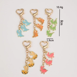Cute cartoon dinosaur keychain set with heart-shaped gold clasp and colorful pendants