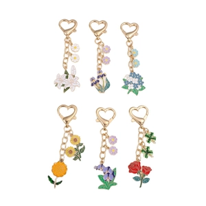 Set of six floral metal keychains featuring colorful enamel hydrangea and lily designs