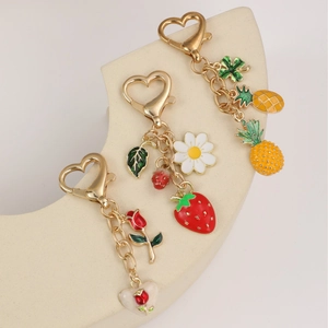 Cartoon fruit gold metal keychains featuring strawberry and pineapple pendant charms