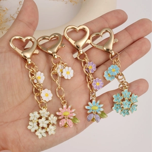 Set of four floral heart keychains with gold heart clasps in white, pink, blue and purple