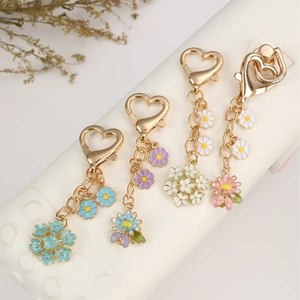 Colorful floral heart keychains with ladybug charms in blue, purple, white and pink colors