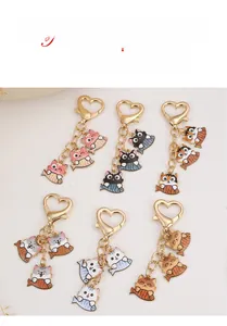Flat lay of alloy cat keychains with heart-shaped clasps in six different vibrant colors