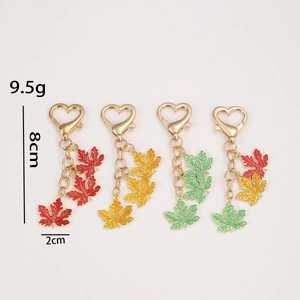 Colorful maple leaf keychains with heart metal clasp and enamel charms in various colors