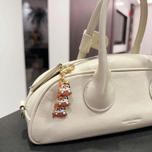 White leather handbag featuring three cute cartoon cat holding fish enamel charms