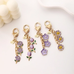 Set of 4 gold tulip and rose alloy keychains with purple enamel and handmade charms