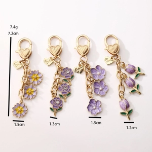 Charming purple floral alloy keychains with tulip and rose designs in gold finish