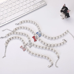Detail of pet pearl collars with bone-shaped rhinestone pendants and adjustable lobster clasp