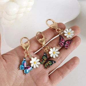 Colorful butterfly and daisy enamel keychains with heart-shaped clasps in three colors