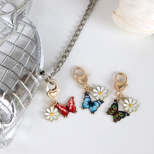 Colorful butterfly keychain set with daisy charms and golden heart lobster clasps for bags