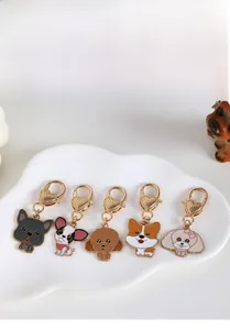 Detailed view of cartoon dog alloy charms with heart-shaped clasps and gold plating