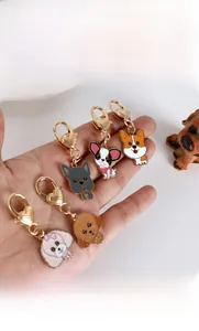 Detail of dog charms with gold heart-shaped clasps and vibrant enamel finish