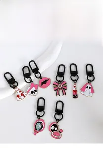 Flat lay detail of pink and black gothic Halloween enamel metal keychains collection