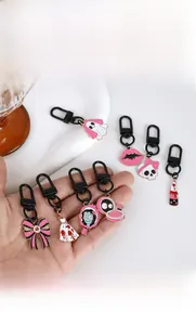 Detail of pink ghost and skull enamel keychains with matte black metal alloy hardware