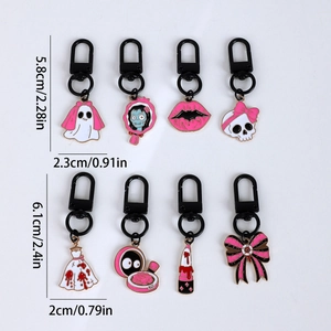 Set of 8 pink Halloween enamel keychains with ghost and skull charms on white background