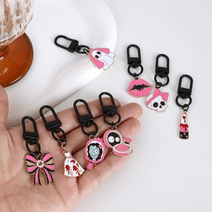Pink Halloween enamel keychain set featuring ghost skull and lipstick charms for bags