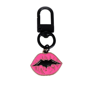 Pink enamel lips keychain with black bat design on a matte metal ring for bags