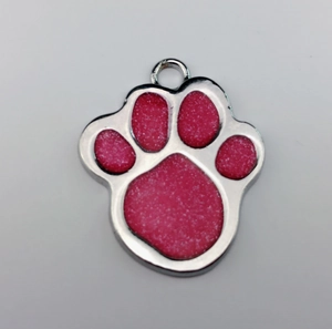 Detailed view of paw-shaped zinc alloy pet ID tag with sparkling pink glitter finish