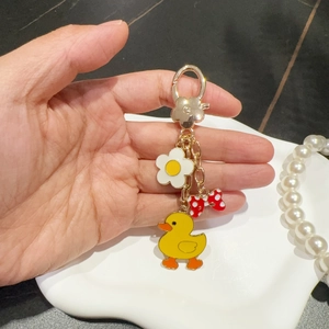 Exquisite cartoon yellow duck keychain with white flower and bow on gold metal clasp