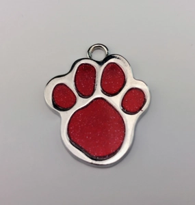 Detail view of red glitter paw print pet ID tag with polished silver metal border