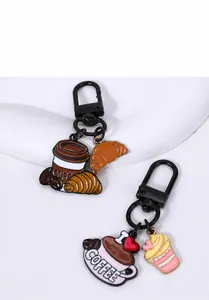 Detail of cartoon coffee and dessert metal keychains with matte black metal clips
