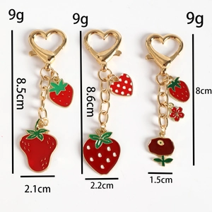 Three strawberry metal keychains with red enamel charms and heart lobster clasps