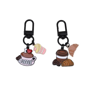 Cute coffee-themed enamel keychain set with croissant and coffee bean charms