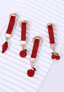 Detailed close-up of sparkling red rhinestone cherry and strawberry metal keychains