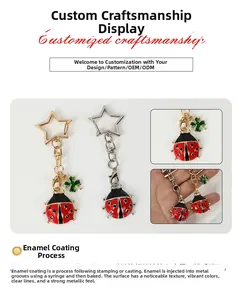 Detail of red ladybug keychain with green clover charm and star-shaped ring clasp