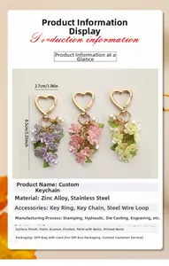 Detail view of heart-shaped flower keychain charms in purple pink and yellow zinc alloy
