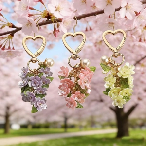 Floral cherry blossom keychain with gold heart clip and pearl charm on a tree branch