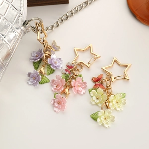 Star-shaped zinc alloy keychains with colorful cherry blossoms and enamel butterflies