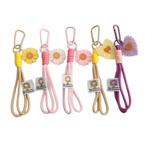 Set of five woven rope phone straps with sunflower charms and quote tags on white background