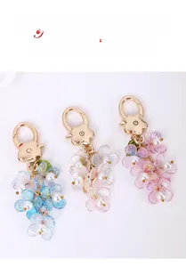 Detailed close-up of gradient petal floral keychains with pearls and gold heart clasps