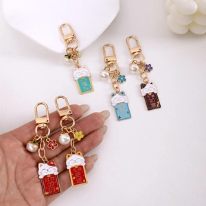 Set of five cute lucky cat enamel keychains with floral charms and pearl details