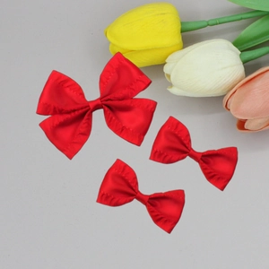 Detailed macro view of three vibrant red pleated satin ribbon bows for elegant hair accessories