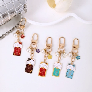 Five pieces of cute lucky cat keychains with colorful enamel flowers and pearls