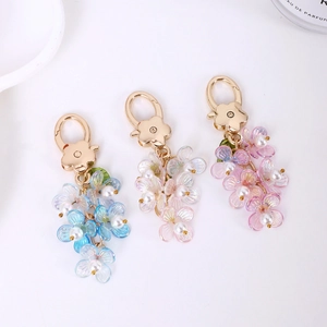Charming luminous flower keychain set with iridescent petals and pearl accents in gold