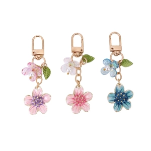 Minimalist cherry blossom enamel keychains with pearls in pink, purple and blue tones