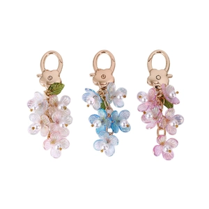 Exquisite pearl flower keychain set with glowing floral charms in three pastel colors