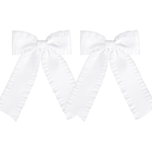 Detail of white satin bow hair clips featuring ruffled edges and long ribbon streamers