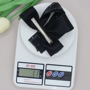 Elegant double-layered black bow hair clip with silver rhinestones weighing 11 grams