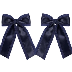 Detailed close-up of navy blue double-layered bow hair clips with pleated edges and ribbons